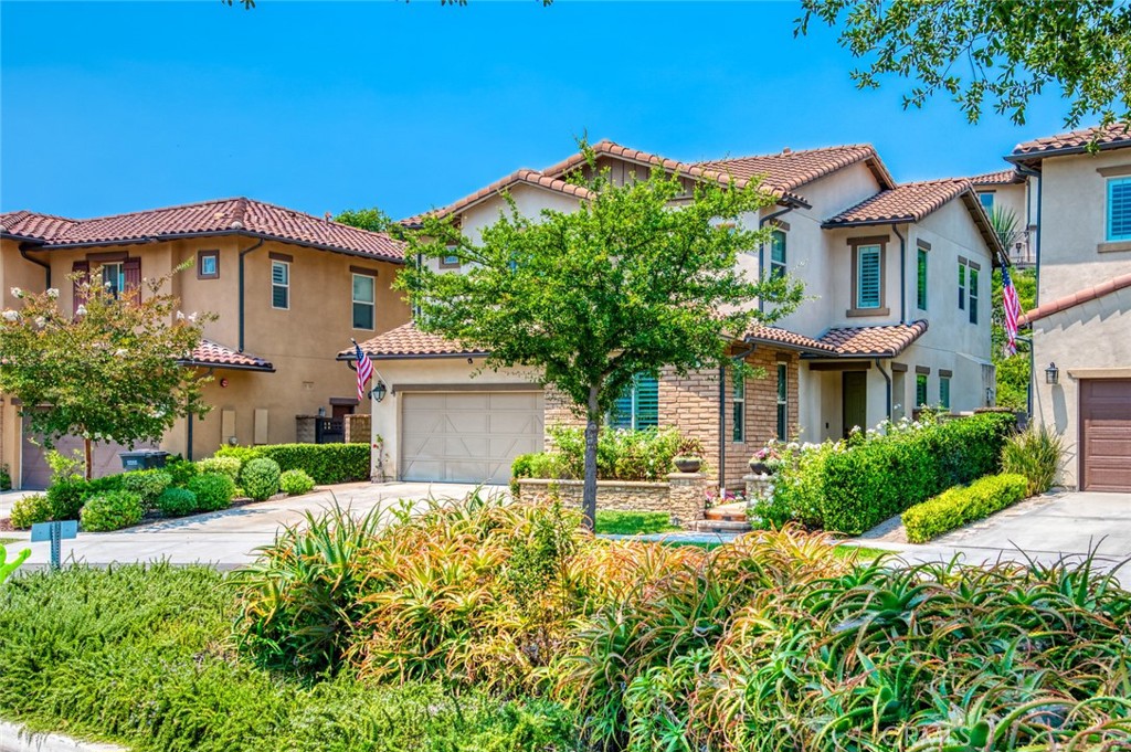 33 Lucido Street Rancho Mission Viejo, CA 92694 - Photo 2 of 37 a front view of a house with a yard and garage