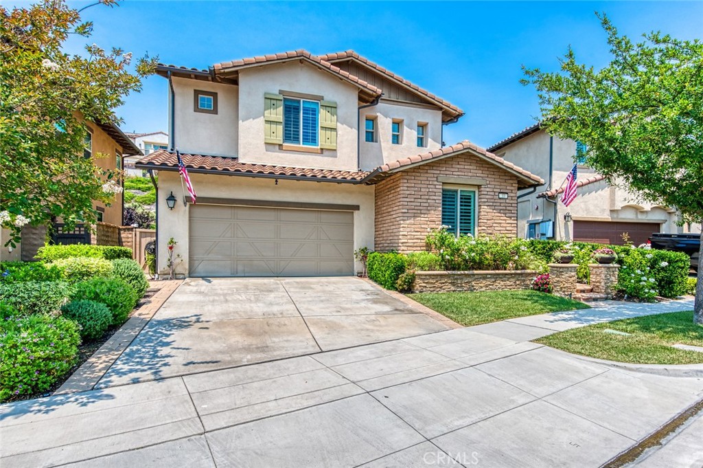 33 Lucido Street Rancho Mission Viejo, CA 92694 - Photo 3 of 37 a view of a house with a yard and plants