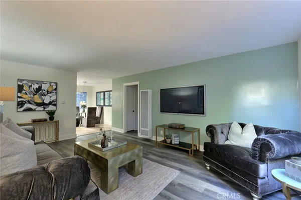 a living room with furniture and a flat screen tv