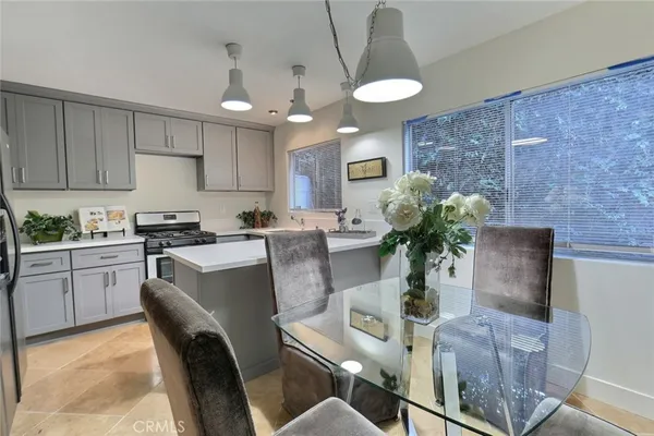 a kitchen with stainless steel appliances granite countertop sink stove top oven and cabinets