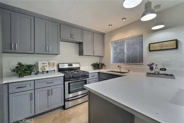 a kitchen with stainless steel appliances white cabinets and a stove top oven