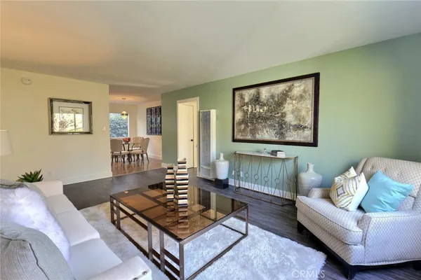 a living room with furniture and a potted plant
