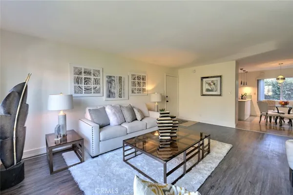 a living room with furniture rug and wooden floor