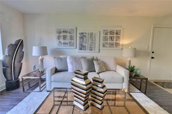 a living room with furniture a rug and a table