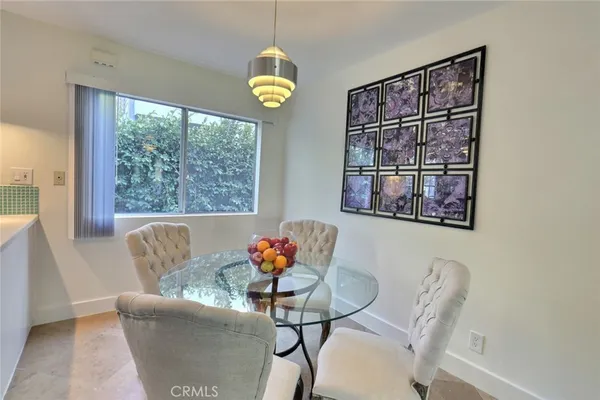 a dining room with furniture and a window