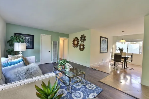 a living room with furniture and wooden floor