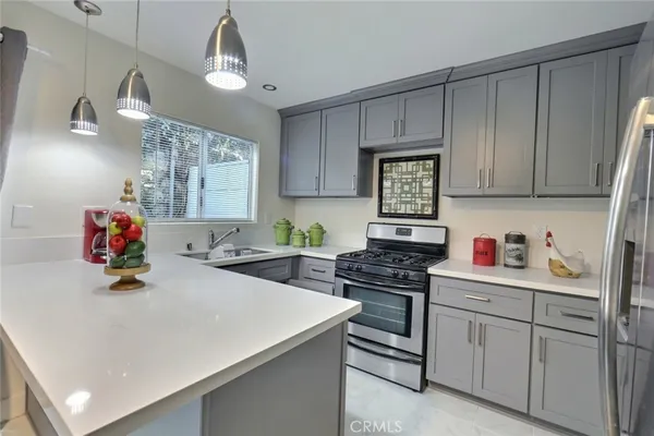 a kitchen with a sink a stove and cabinets