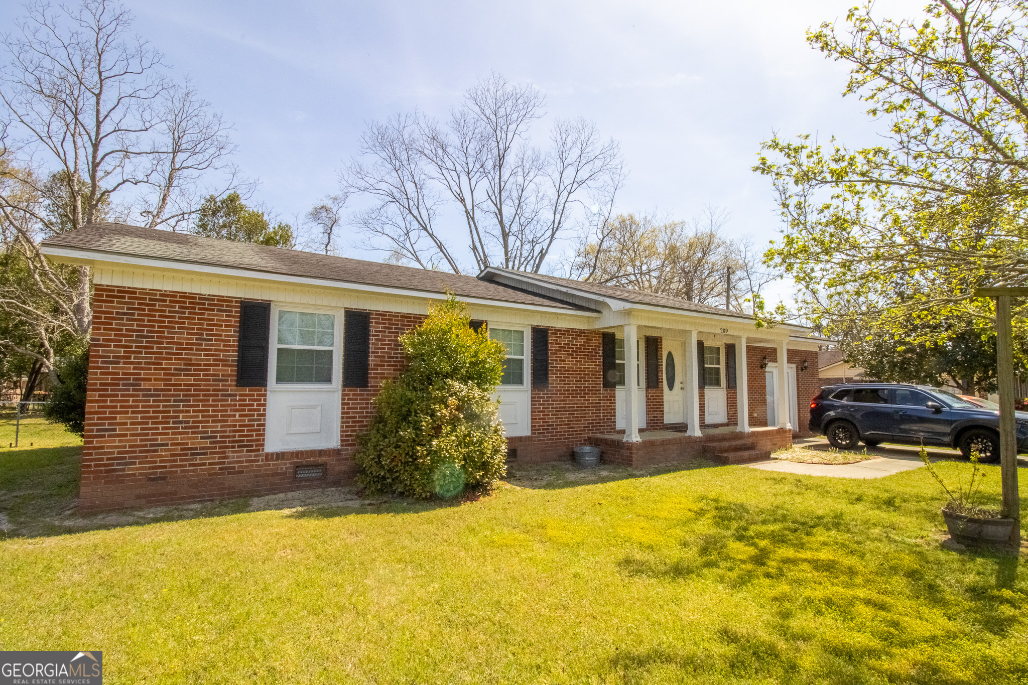 209 Elm Drive Brooklet, GA 30415 - Photo 1 of 30 a front view of house with swimming pool and porch with furniture