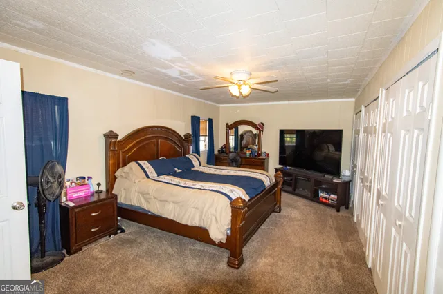 a bedroom with bed and a chandelier