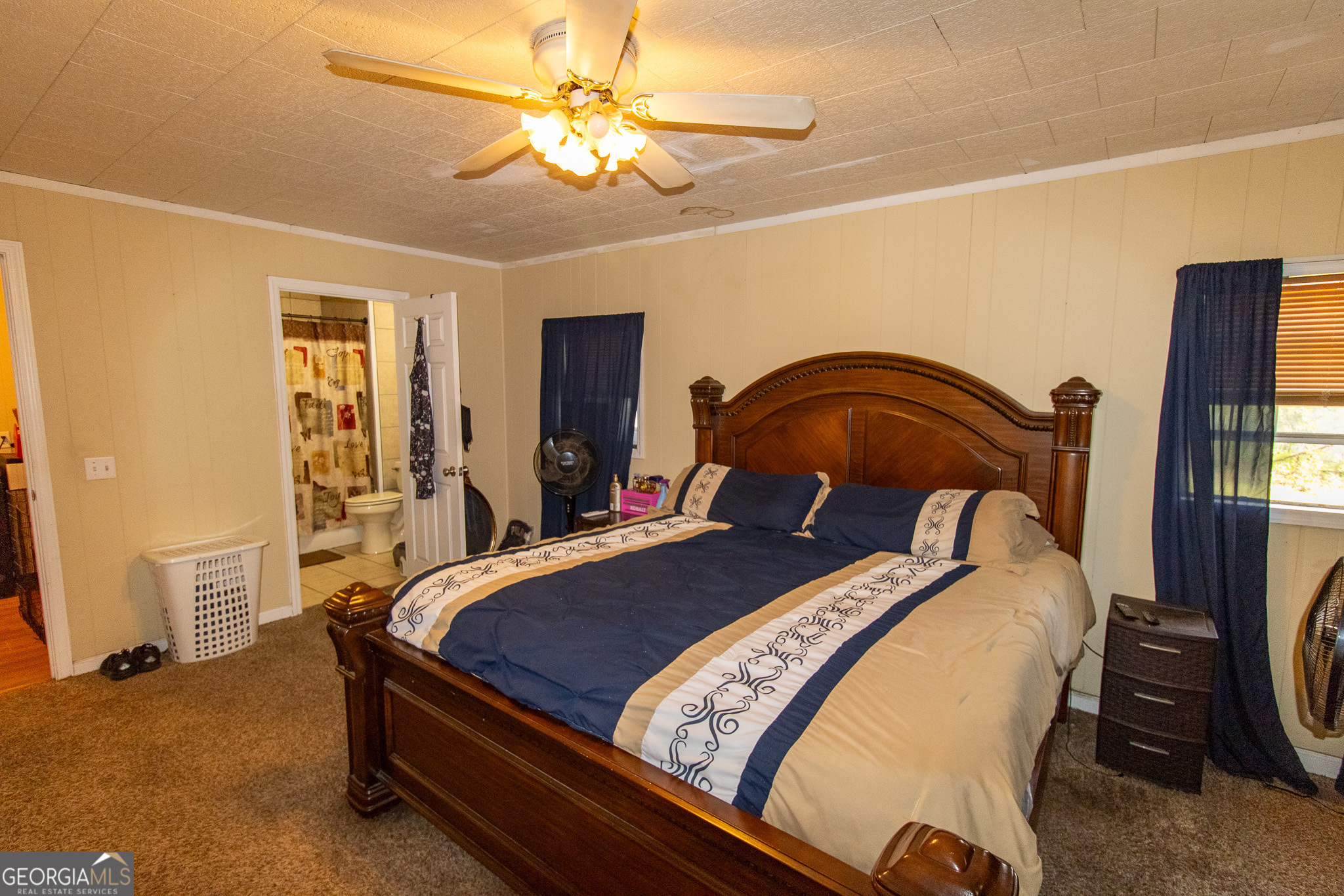 209 Elm Drive Brooklet, GA 30415 - Photo 13 of 30 a bedroom with a bed and a chandelier