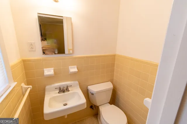 a bathroom with a toilet and a sink