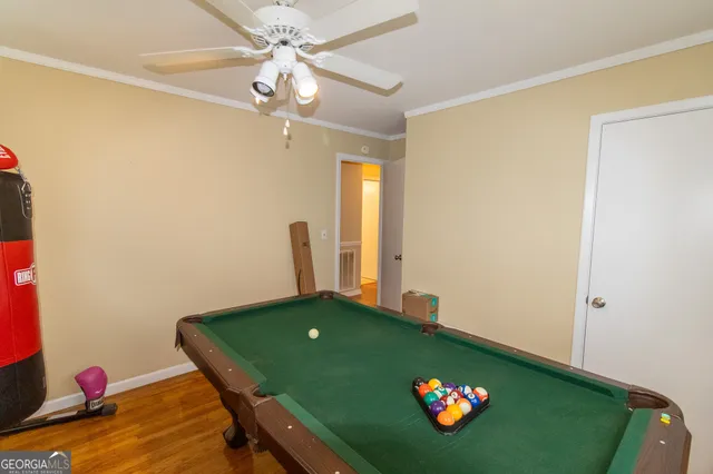 a room with furniture and a chandelier fan