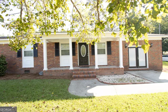 a front view of a house with garden