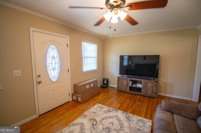 a living room with furniture and a flat screen tv