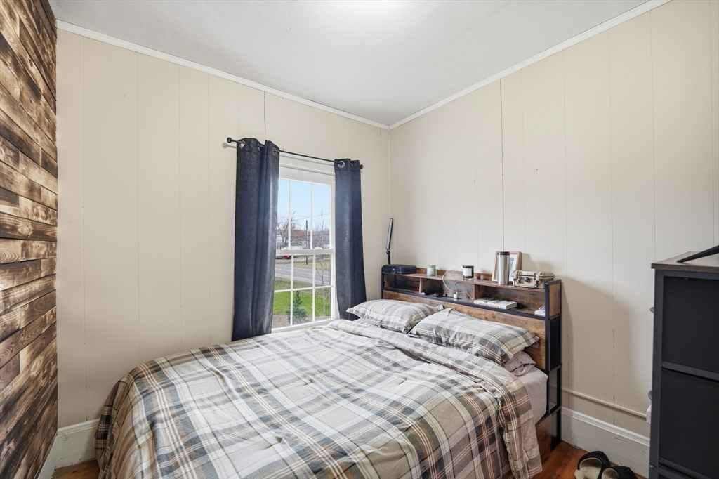 79 State Road Whately, MA 01373 - Photo 28 of 40 a bedroom with a bed and a large mirror