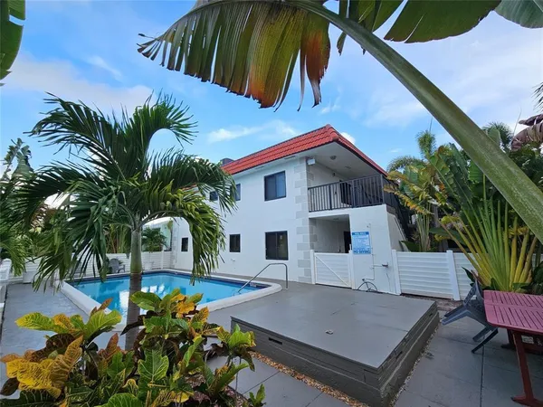 a view of house with swimming pool outdoor seating