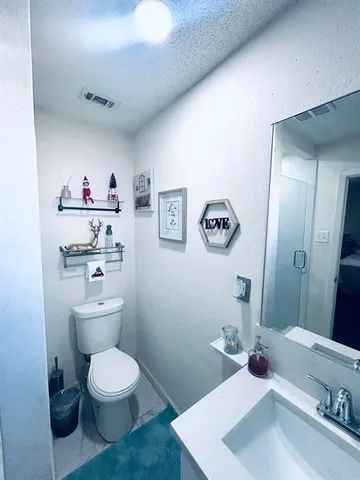a bathroom with a toilet a sink and a mirror