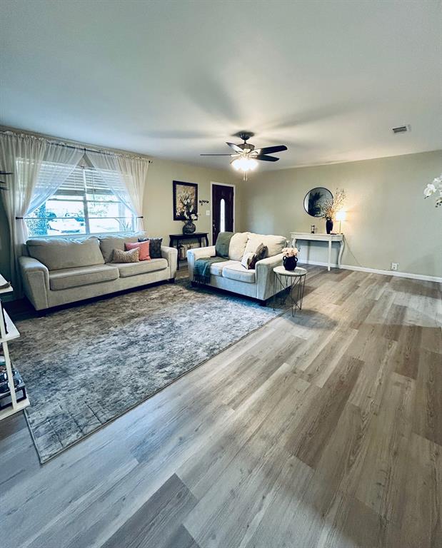 307 East 5th Street Kaufman, TX 75142 - Photo 2 of 27 a living room with furniture and a chandelier