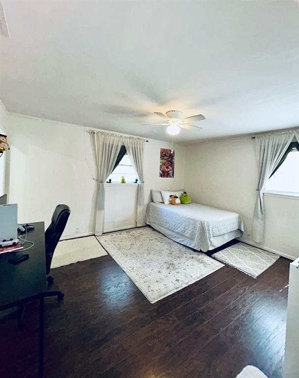 307 East 5th Street Kaufman, TX 75142 - Photo 24 of 27 a bedroom with furniture and a wooden floor