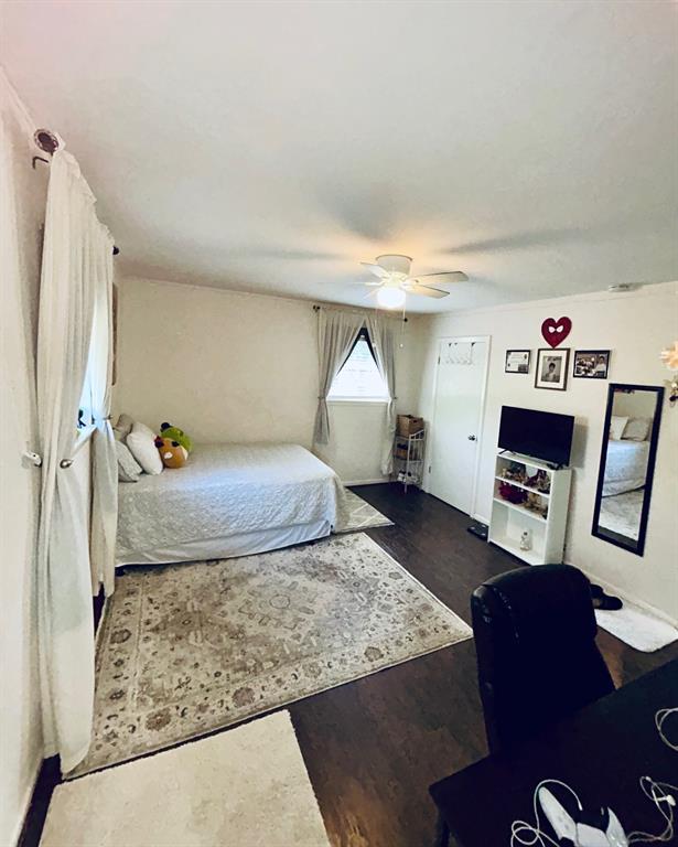 307 East 5th Street Kaufman, TX 75142 - Photo 25 of 27 a bed room with a bed and a couch