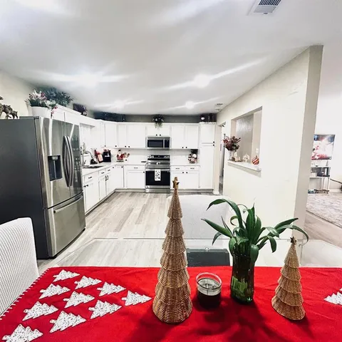a living room with furniture and a kitchen