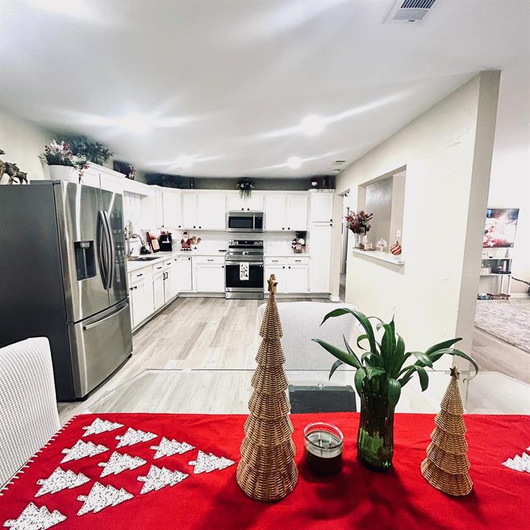 307 East 5th Street Kaufman, TX 75142 - Photo 8 of 27 a living room with furniture and a kitchen