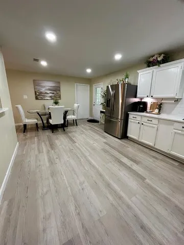 a large room with lots of chairs and wooden floor