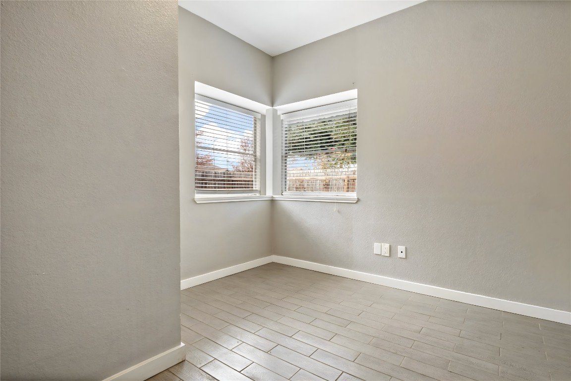 16801 Gravesend Road Pflugerville, TX 78660 - Photo 15 of 30 Bedroom #2 featuring a textured wall and wood finished floors