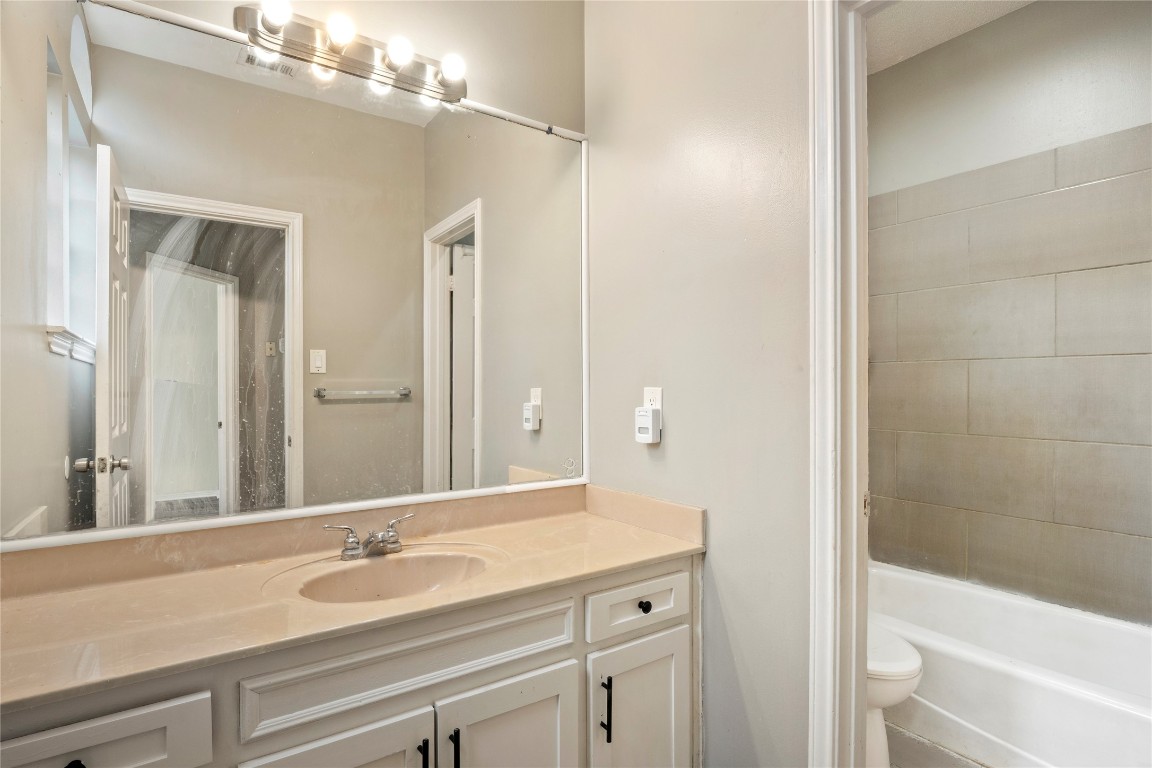 16801 Gravesend Road Pflugerville, TX 78660 - Photo 20 of 30 Bathroom featuring vanity and washtub / shower combination