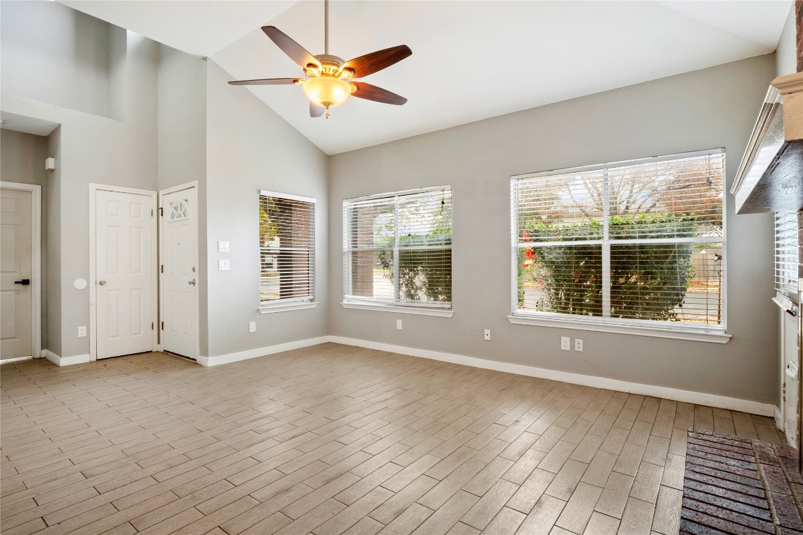 16801 Gravesend Road Pflugerville, TX 78660 - Photo 5 of 30 Living room featuring high vaulted ceiling, ceiling fan, and wood finish floors