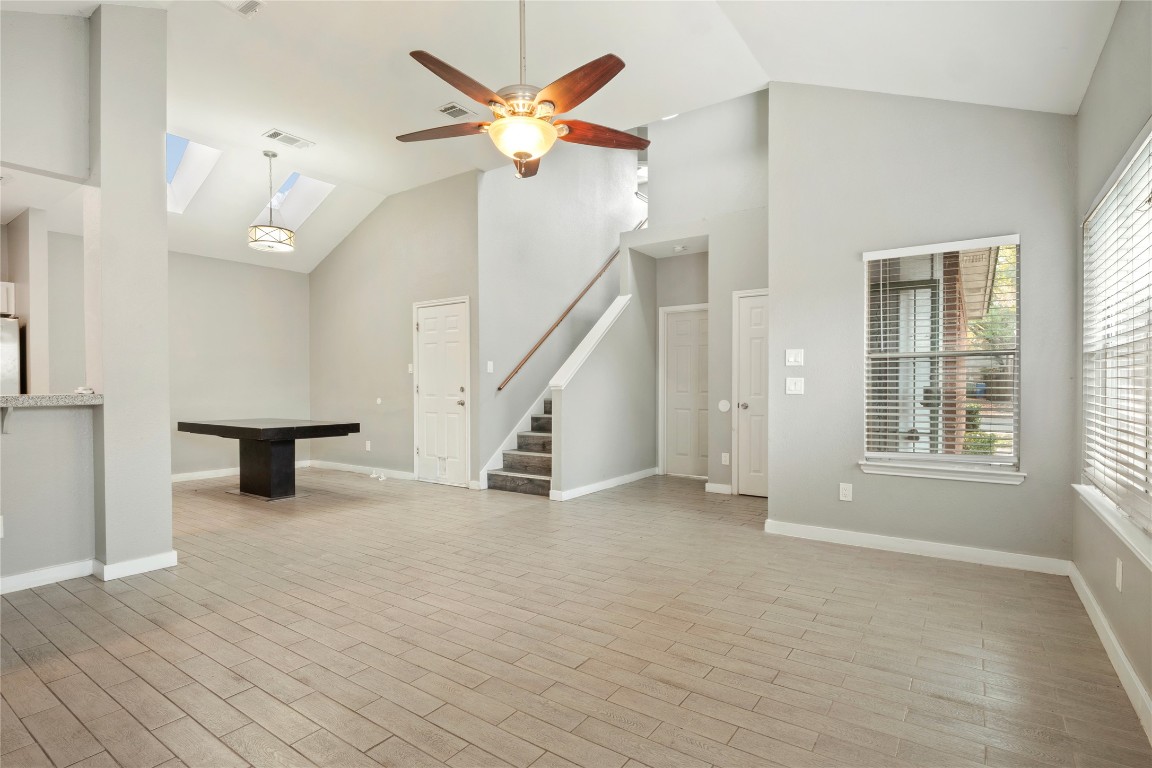 16801 Gravesend Road Pflugerville, TX 78660 - Photo 6 of 30 Living room featuring high vaulted ceiling, ceiling fan, and wood finish floors
