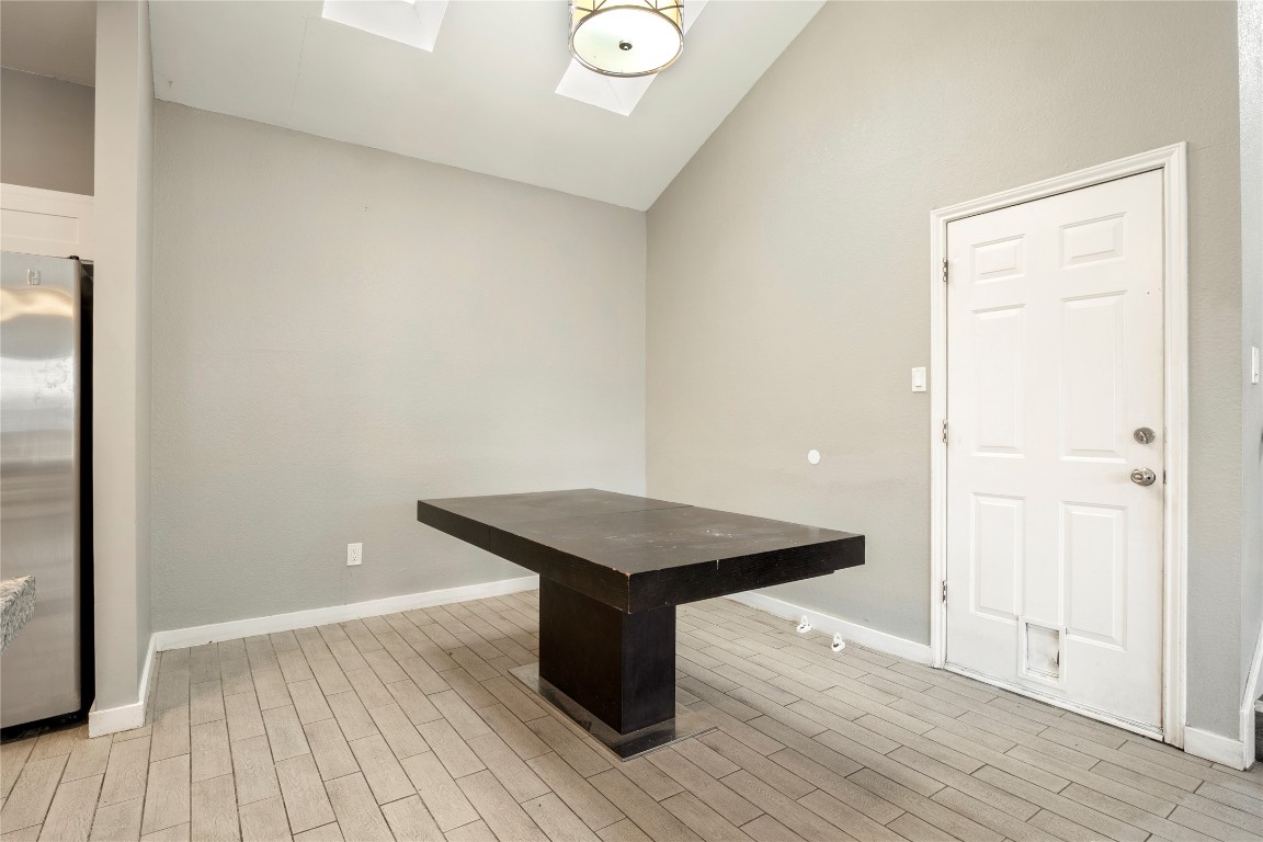 16801 Gravesend Road Pflugerville, TX 78660 - Photo 9 of 30 Dining area feating high vaulted ceiling and wood finished floors