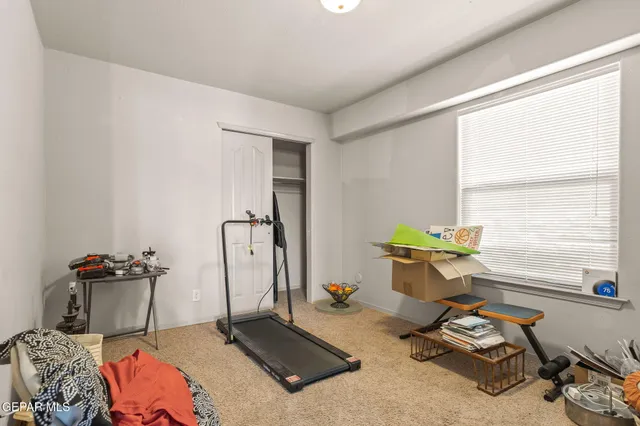 a bedroom with furniture and a window