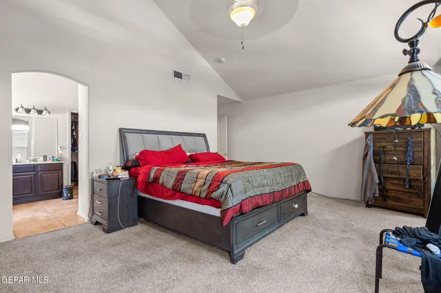 a bedroom with a bed and a dresser