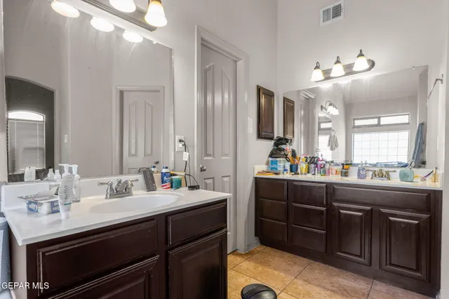 a bathroom with a sink double vanity and a mirror