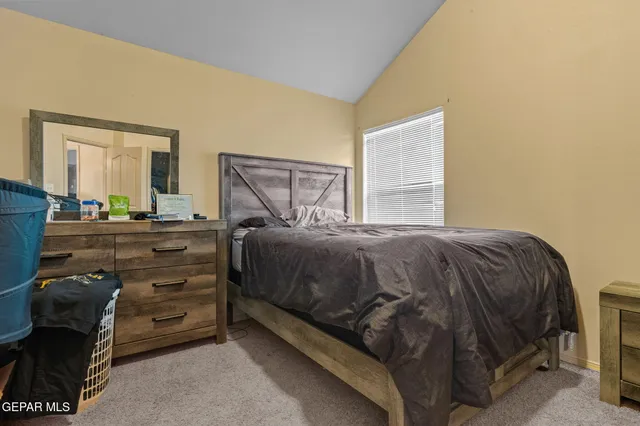 a bedroom with a bed and a dresser