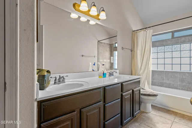 a bathroom with a sink a toilet tub and shower