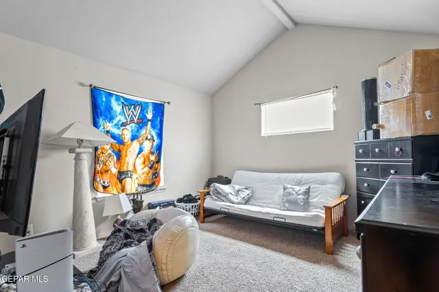 a bedroom with furniture and a flat screen tv