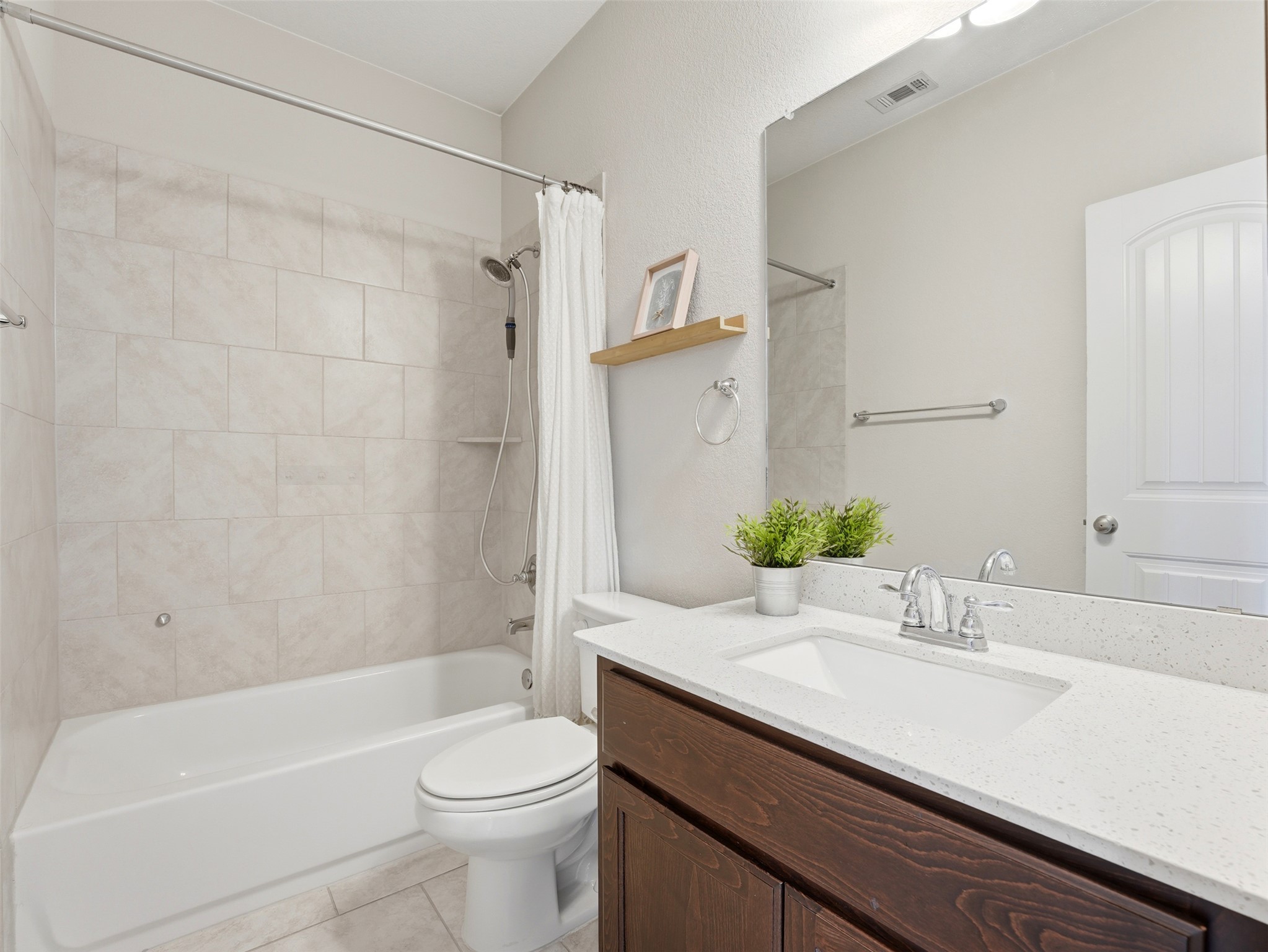 2132 Ringstaff Road Leander, TX 78641 - Photo 22 of 39 A well-appointed bathroom features a single vanity and a shower-tub combination.