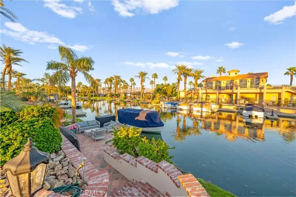 a view of swimming pool from a lounge chairs