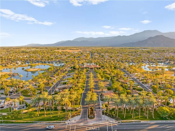 an aerial view of residential houses with outdoor space and swimming pool