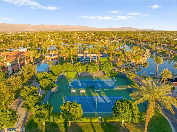 a view of a terrace with couches and wooden fence