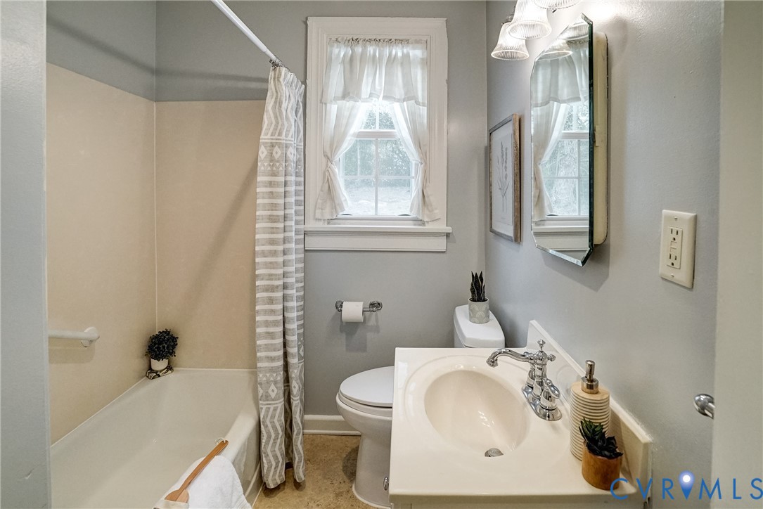 7502 Sweetbriar Road Henrico, VA 23229 - Photo 15 of 28 a bathroom with a sink and a mirror