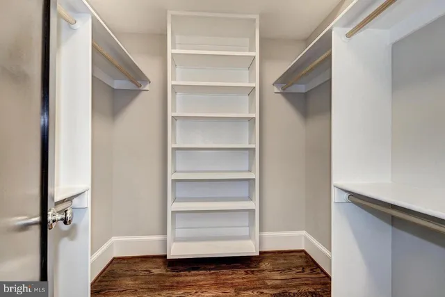 a view of walk in closet with empty racks