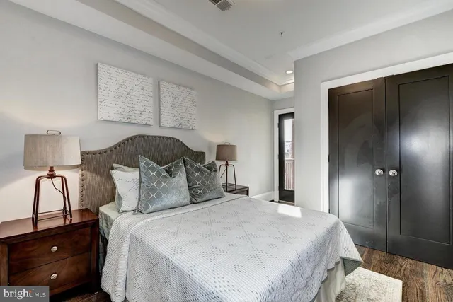 a bedroom with a bed and a night stand