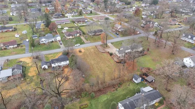an aerial view of a house with a yard and lake view