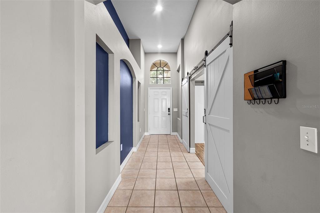 5909 Wedgefield Drive Zephyrhills, FL 33541 - Photo 17 of 54 a view of hallway with stairs