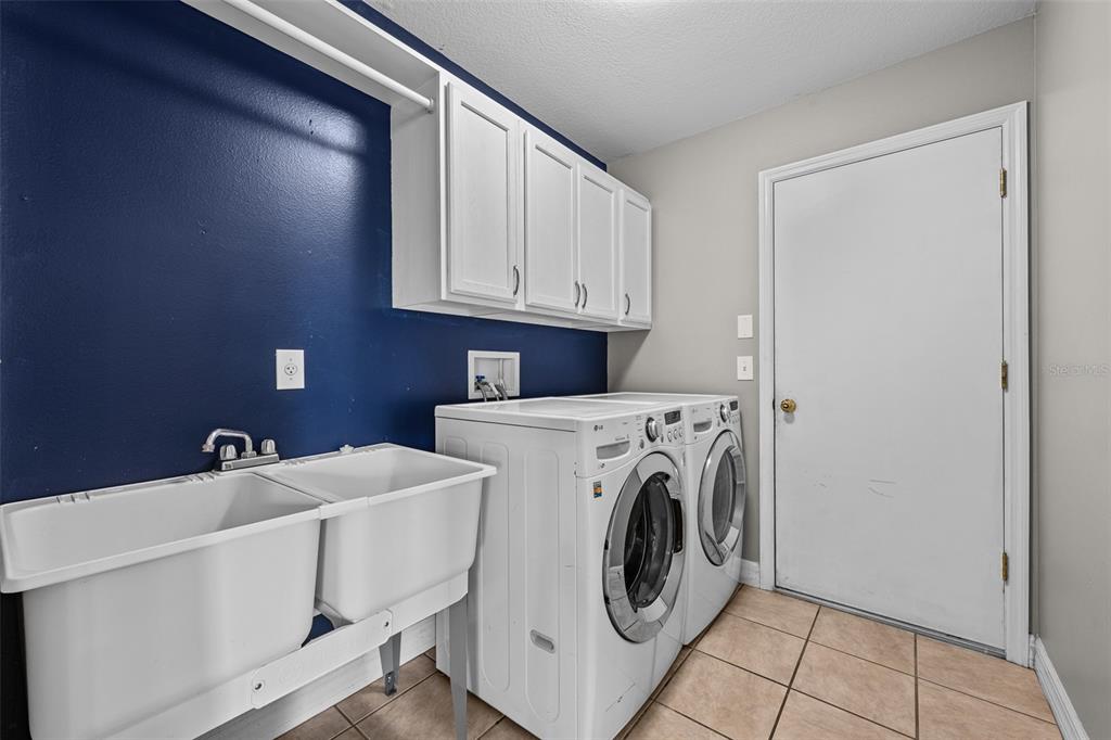 5909 Wedgefield Drive Zephyrhills, FL 33541 - Photo 20 of 54 a utility room with dryer and washer