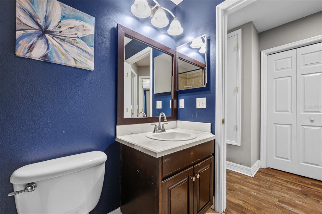 5909 Wedgefield Drive Zephyrhills, FL 33541 - Photo 22 of 54 a bathroom with a toilet a sink and mirror