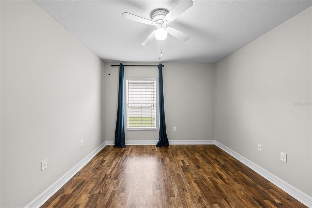 5909 Wedgefield Drive Zephyrhills, FL 33541 - Photo 39 of 54 wooden floor in an empty room